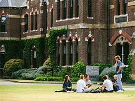 Students enjoying the picturesque ɫapp grounds in front of the most historic building